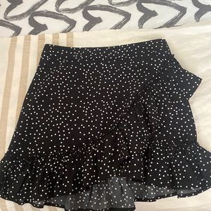 Black and white polka dot skirt with ruffle across front